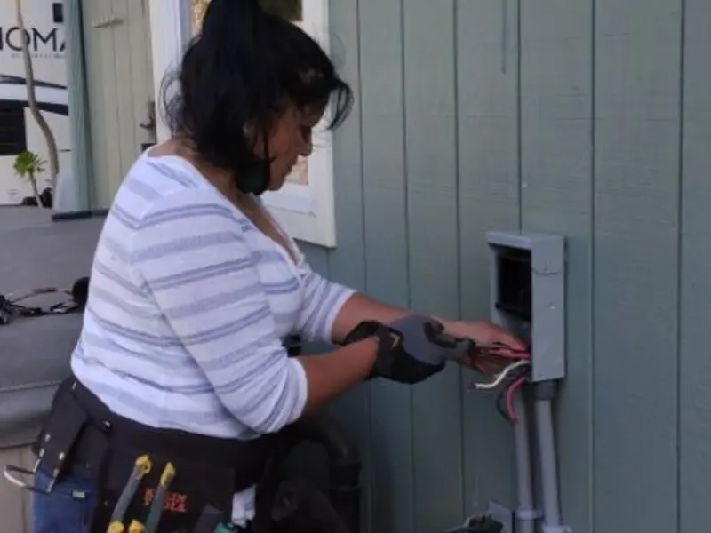 Licensed electrician wiring an exterior subpanel in Brightwaters
